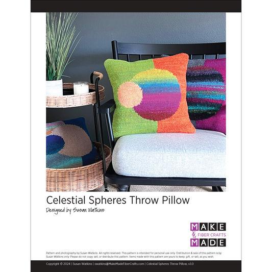 This intarsia design features a split background of one color on the  left and another color on the right. In the center is a large sphere in a third color. A smaller sphere is overlapping, in a complementary color.