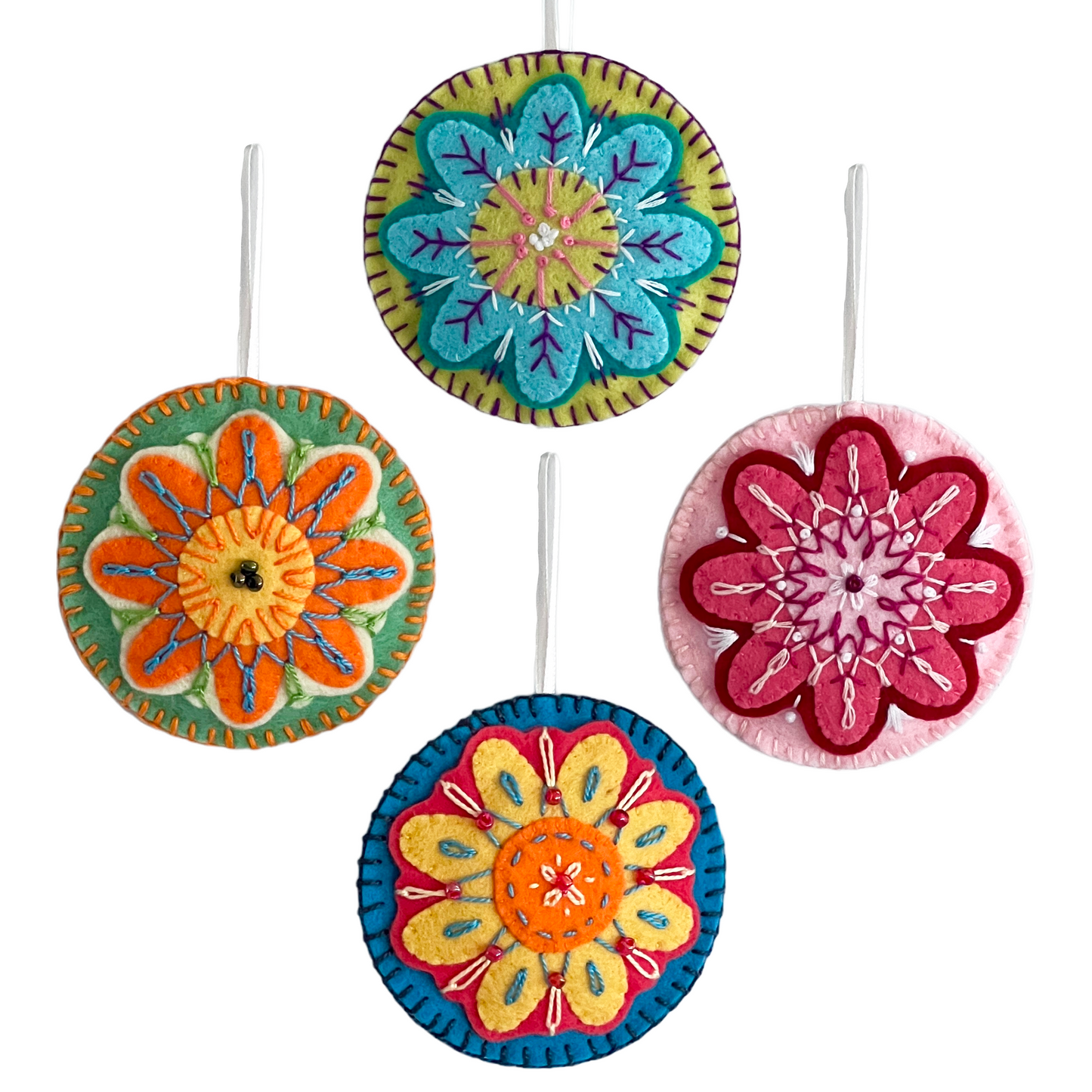 Each Folk Flower ornament is unqiue. Pictured here are four 100% wool felt, hand-stitched ornaments in varied colors.