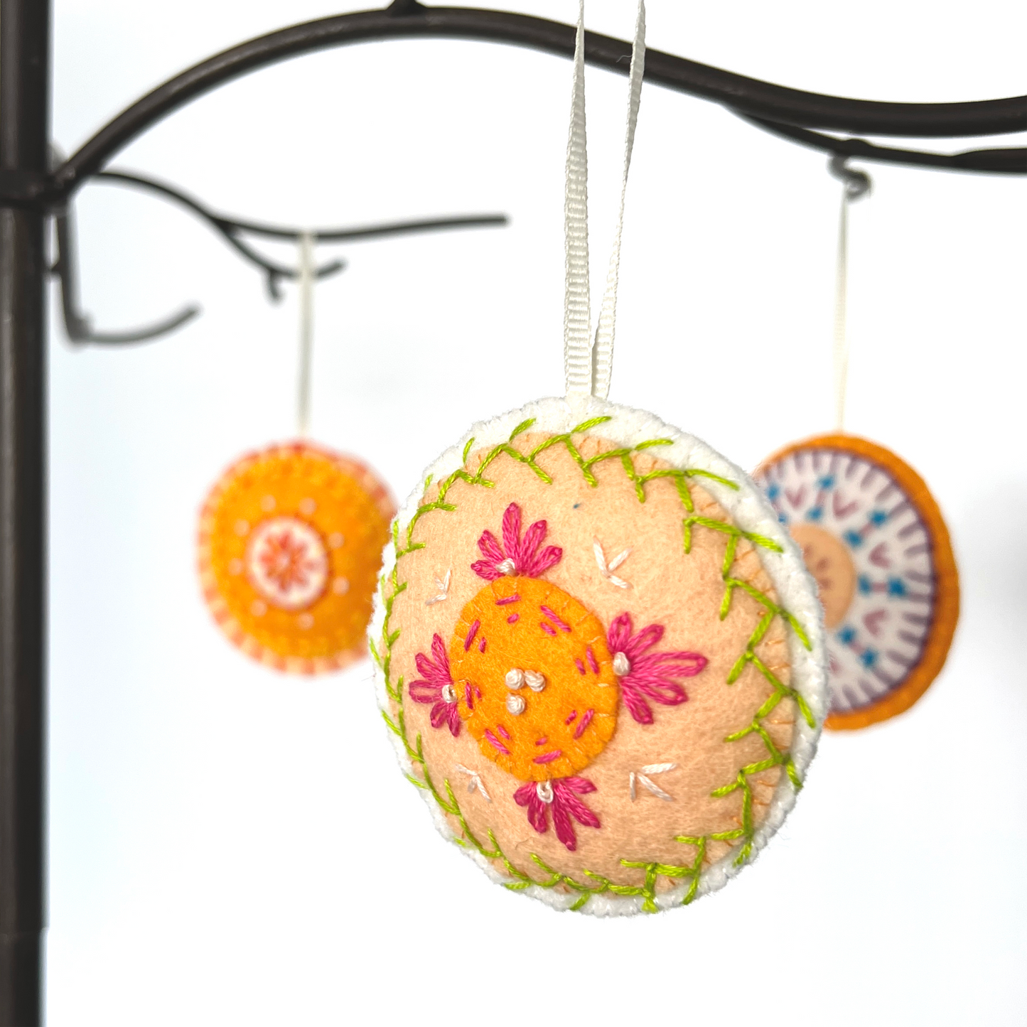 Each Mini Mandala ornament is unqiue. Pictured here are three 100% wool felt, hand-stitched ornaments in varied colors.