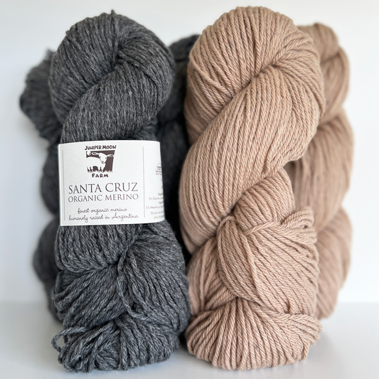 Juniper Moon's Santa Cruz yarns in Smoked (heathered gray) and Driftwood (sandy-colored neutral), displayed side by side.