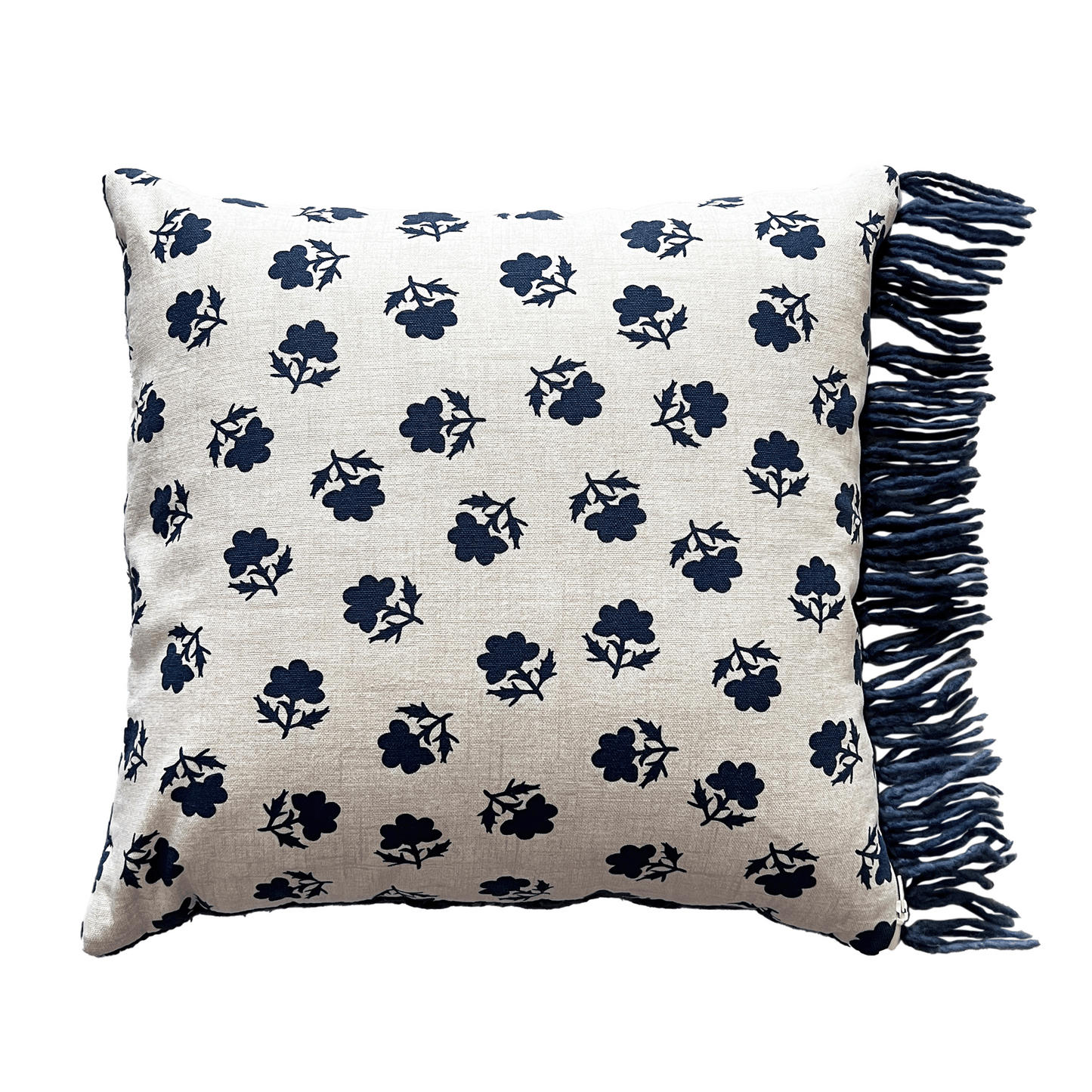 The back of this uniquely fringed pillow is a natural cotton canvas with a medium-sized navy floral print.