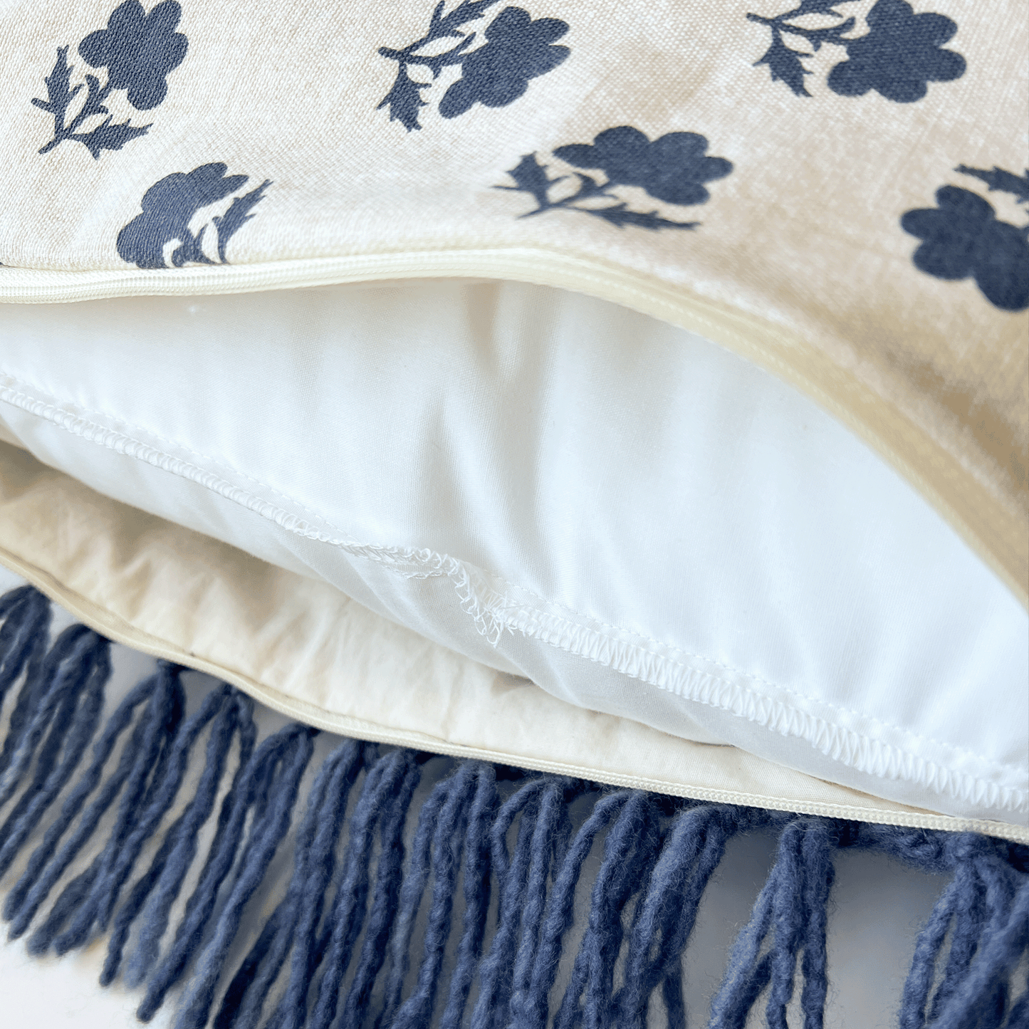 A muslin lining hides the seams in this decorative pillow which sports a side zipper that's covered by the pillow's unique fringe.