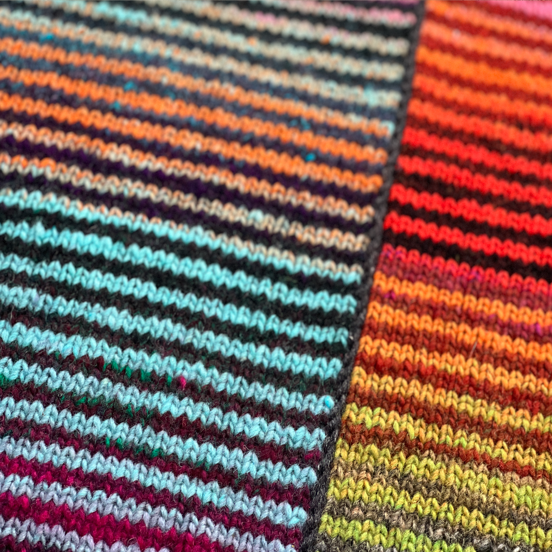 A close up of the pillow's expertly knit front, featuring a kaleidescope of color in alternating stripes!