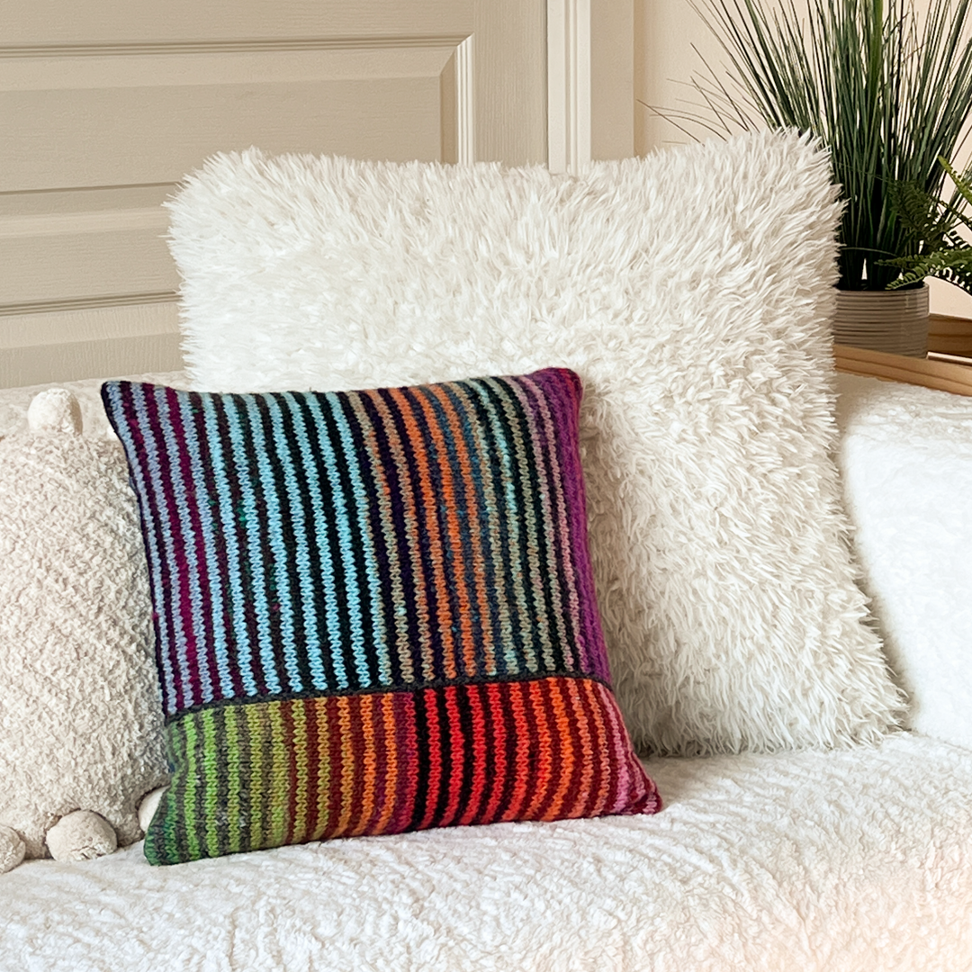 No matter which way you turn it, this 100% hand-knit wool pillow looks great on any couch or chair. Shown here against an off-white couch and pillows.