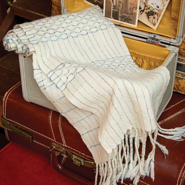 Cirrus Scarf - a honeycomb scarf with curving blue lines on a white background.