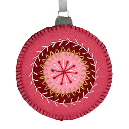 Ornament made from 100% wool felt, displaying concentric circles of rose, cranberry, and pink, embellished with detailed hand embroidery.