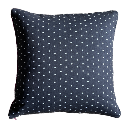 The back side of this pillow is black cotton canvas with a white polka dot print.