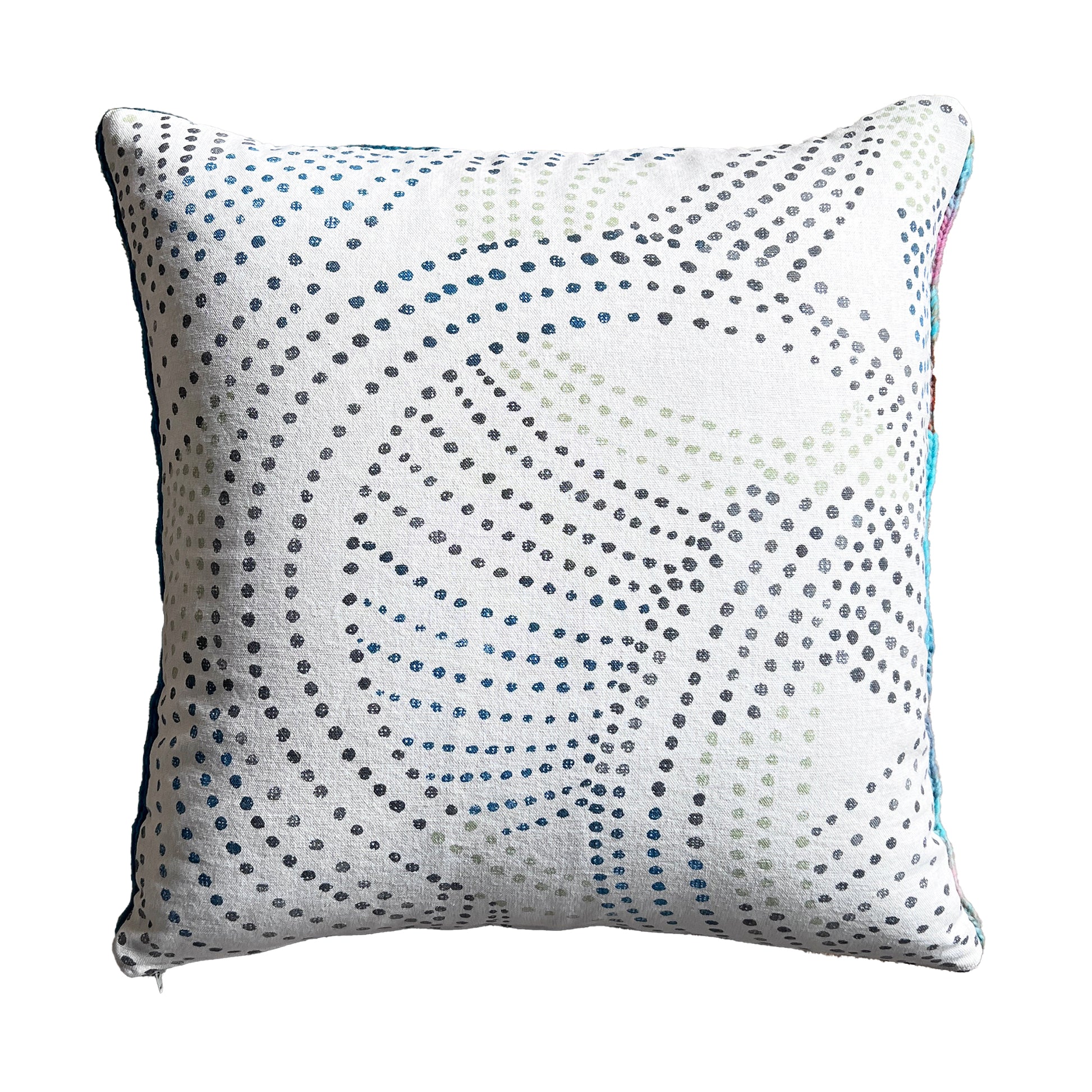 The back side of this pillow is a natural cotton canvas with a geometric, polka dot print with dots of sage, cerulean, and charcoal (which match perfectly with the colors of the yarn).