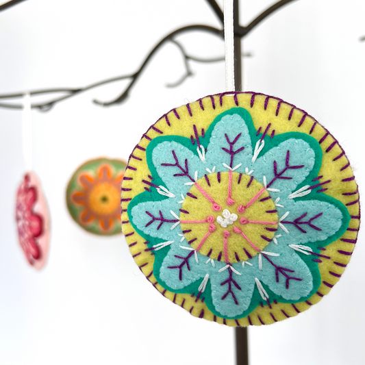 Each Folk Flower ornament is unqiue. Pictured here are four 100% wool felt, hand-stitched ornaments in varied colors.