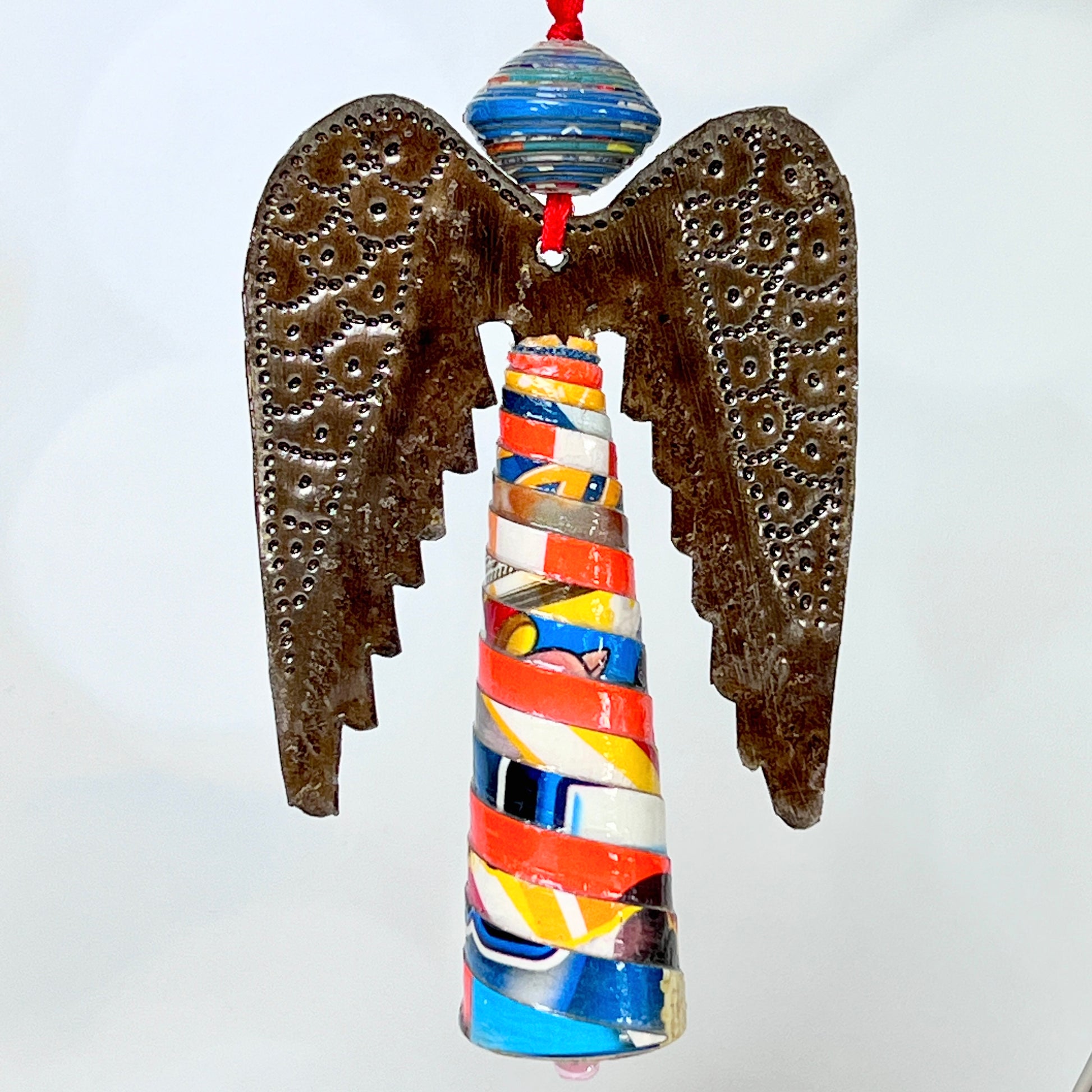 Each Haitian Angel ornament is made of three parts… a hand-coiled paper mache bead for a head, decoratively embossed wings cut from recycled oil drums, and a cone-shaped, colorful paper mache body. No two angels are exactly alike!