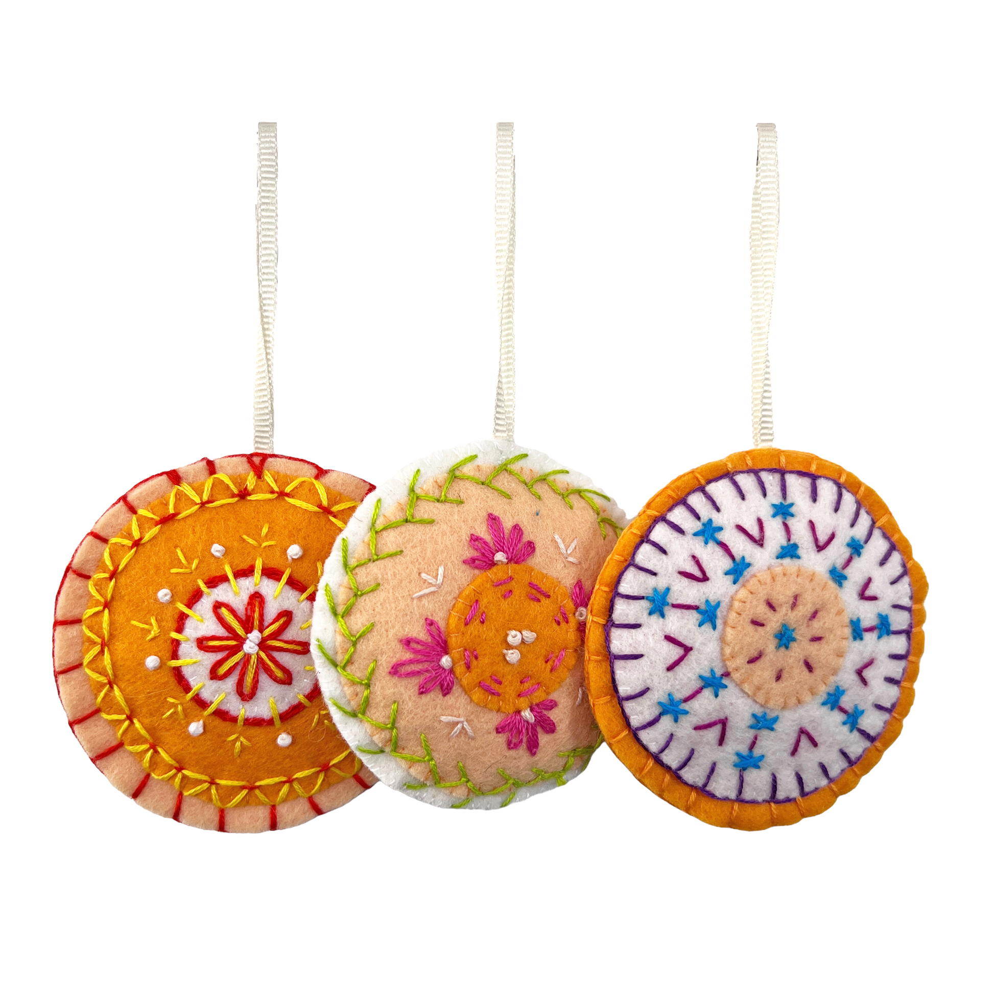 Each Mini Mandala ornament is unqiue. Pictured here are three 100% wool felt, hand-stitched ornaments in varied colors.