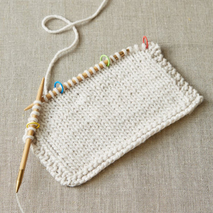 A knit swatch showing the ring stitch markers in use as part of the Cocoknits Method