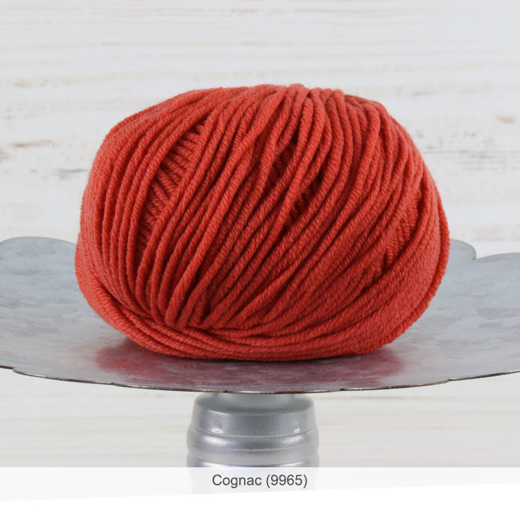One ball of Trendsetter's Merino VIII superwash wool yarn in color #9965 - Cognac